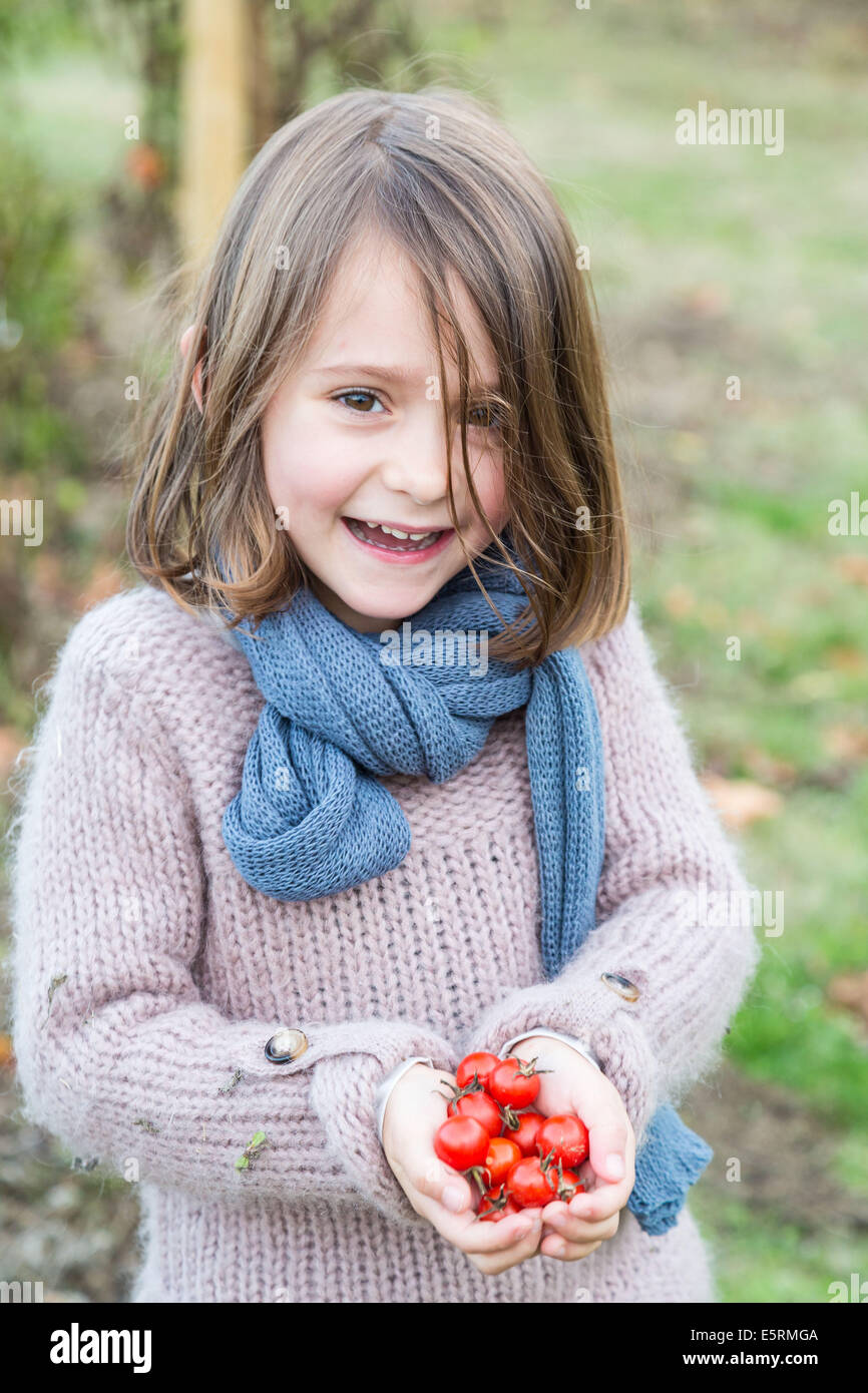 Girl holding tomatoes from garden in the palms of her hands Stock Photo ...