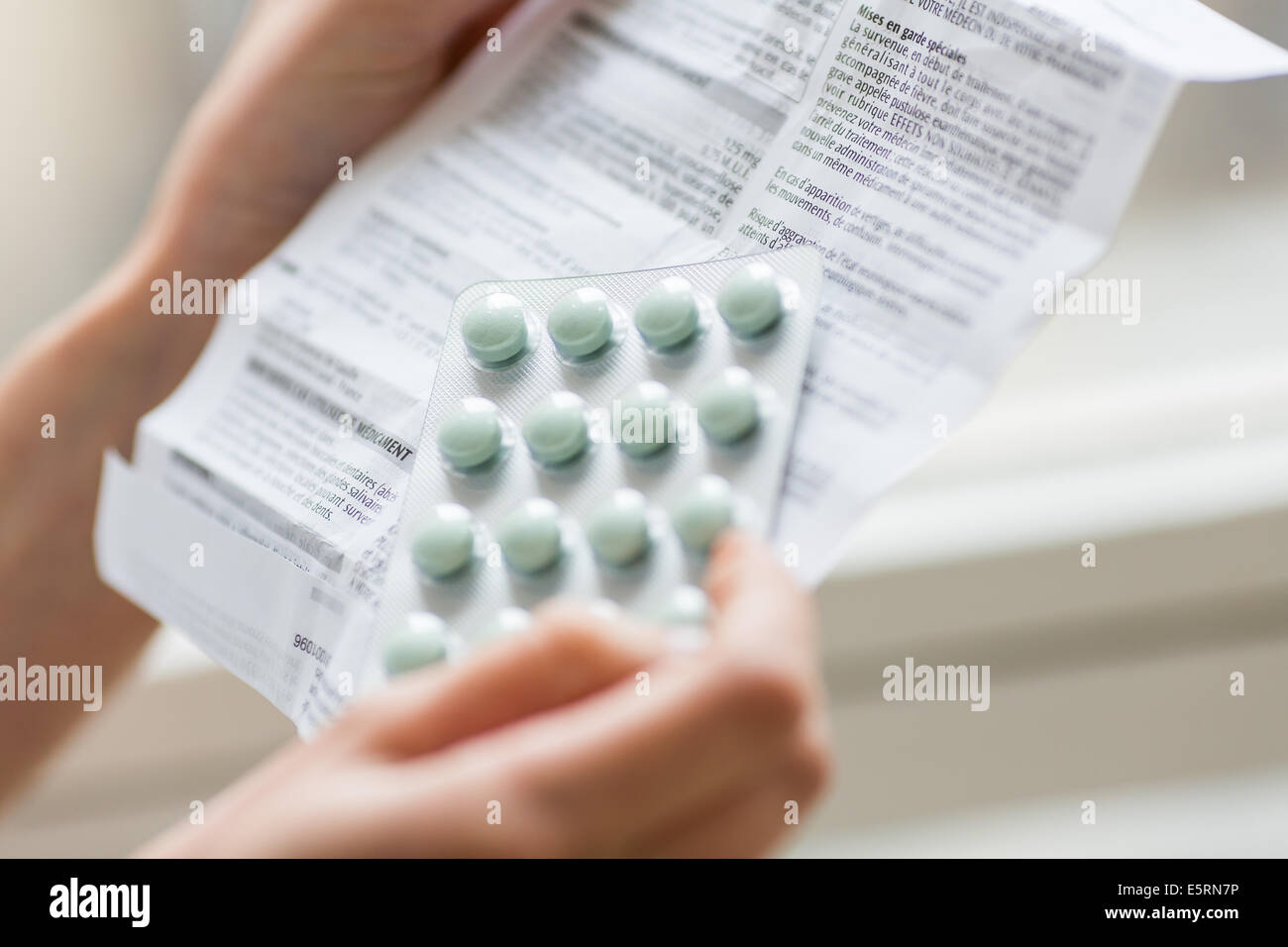 Woman reading medicine instruction sheet Stock Photo Alamy