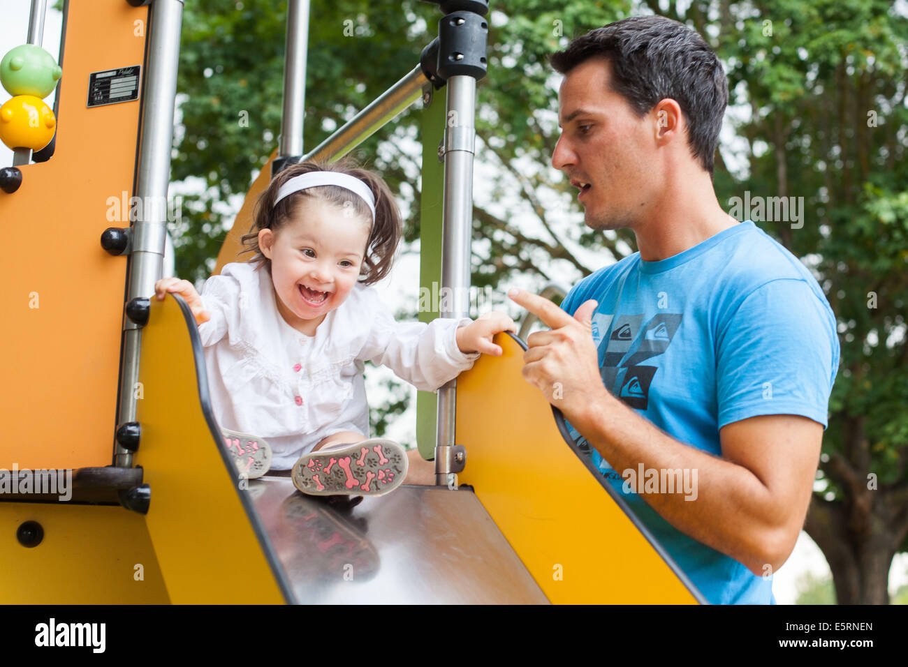 2 and a half year old girl with Down's syndrome with her father Stock