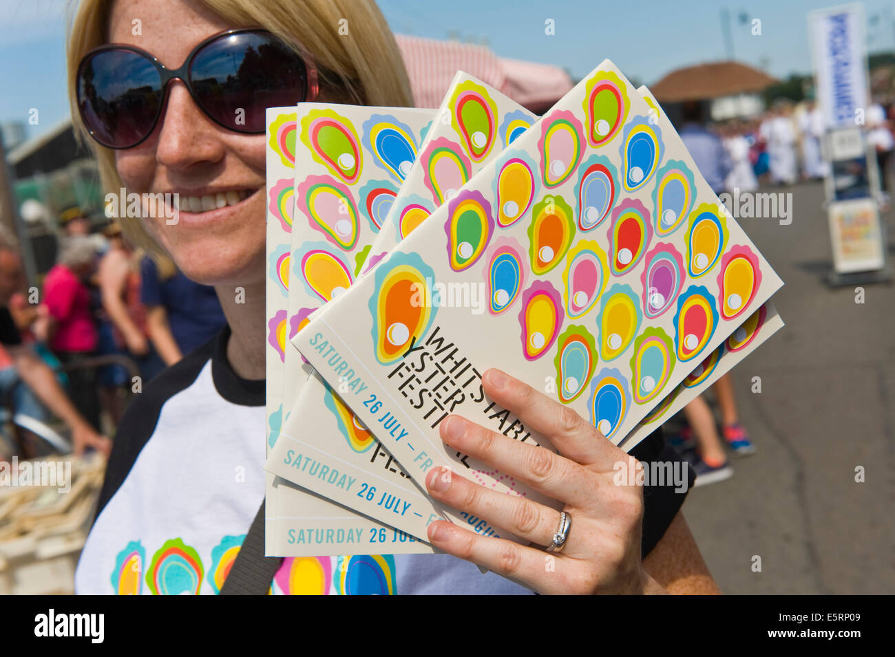 Programme Seller Programme seller in parade at Whitstable Oyster Festival Kent England ...
