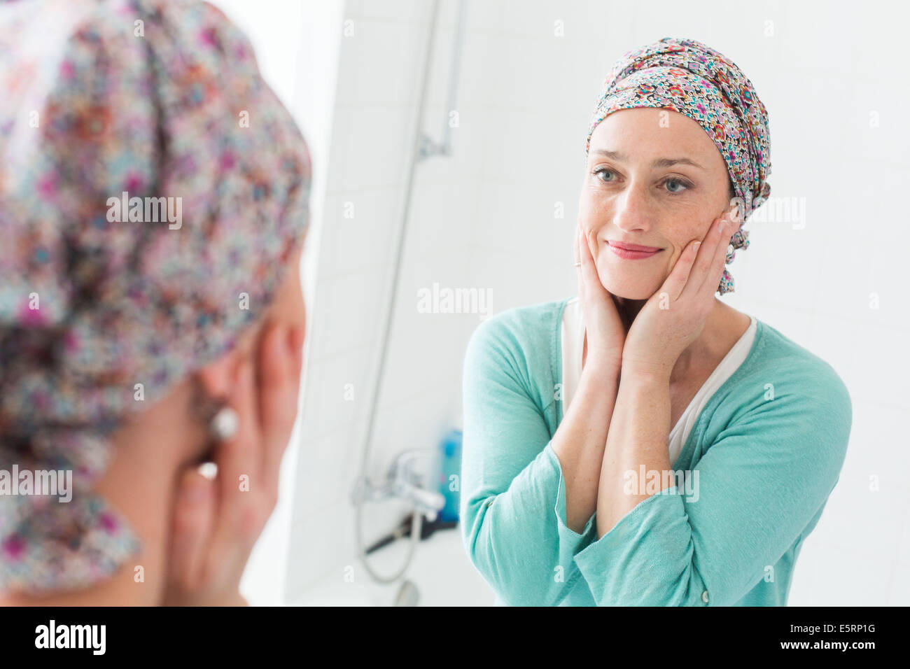 Woman Undergoing Chemotherapy Looking Herself In A Mirror Stock Photo Alamy