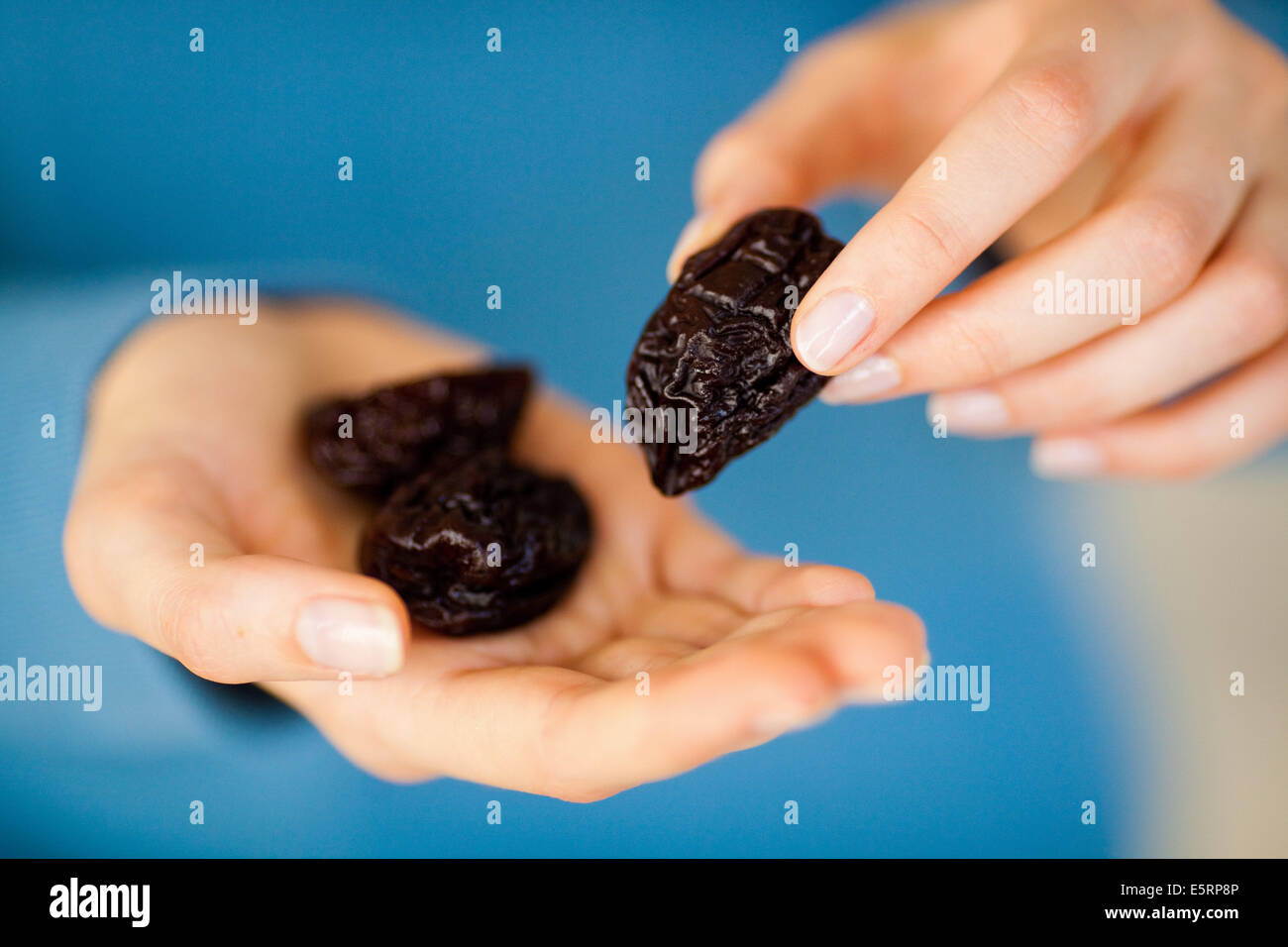 Woman eating prunes Stock Photo Alamy