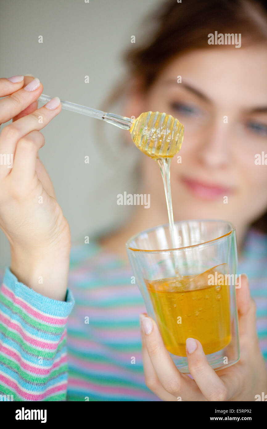 Woman eating honey. Stock Photo