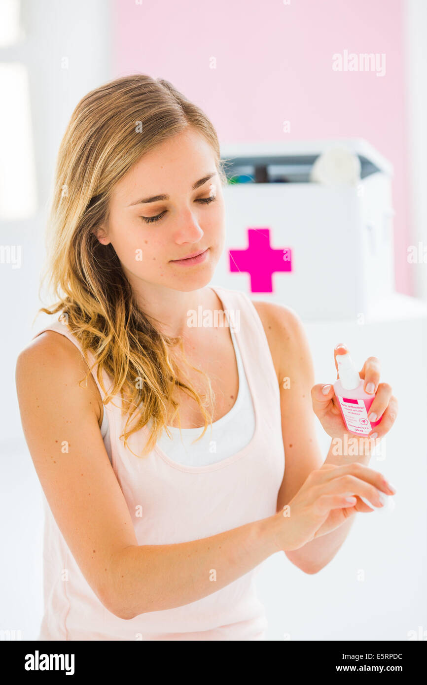 Woman using an antibacterial spray. Stock Photo