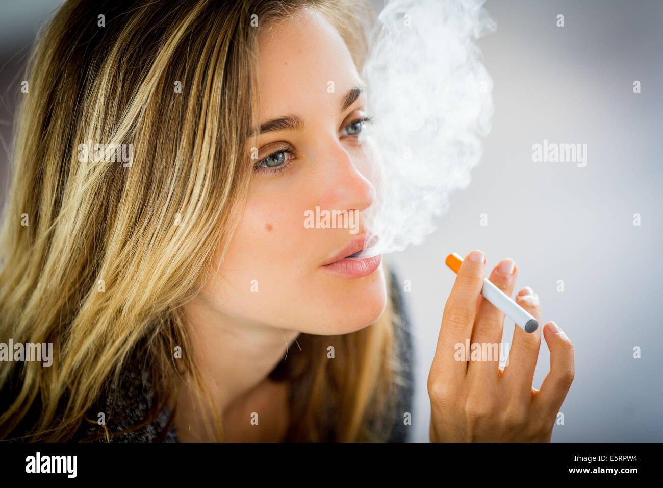 Woman smoking electronic cigarette Stock Photo Alamy