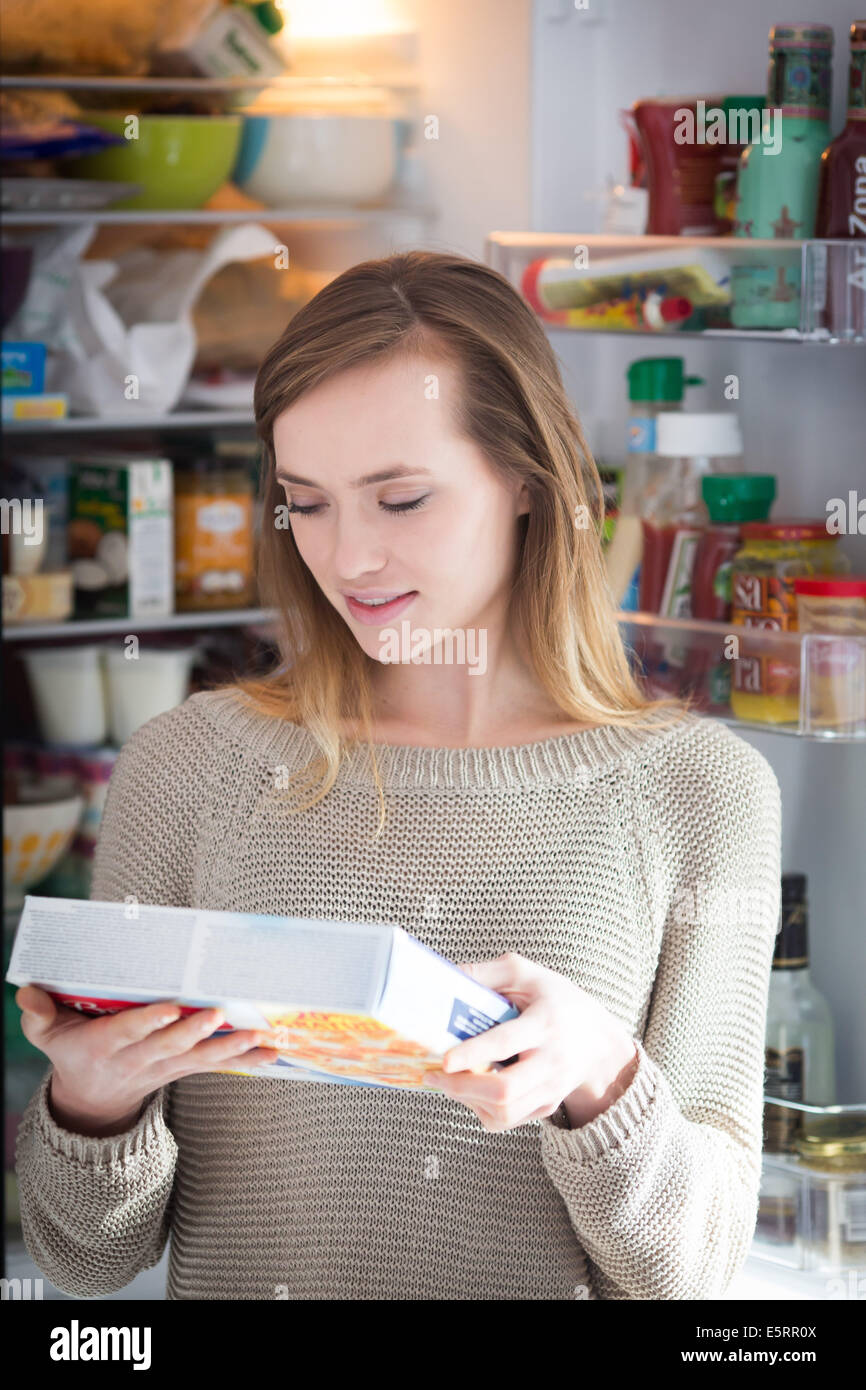 Woman checking the composition and nutrition facts Stock Photo - Alamy