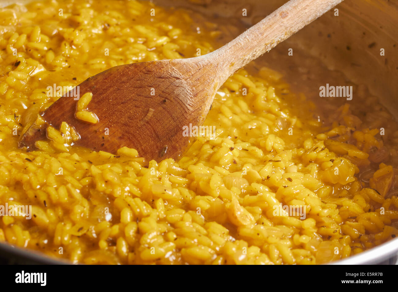 Risotto Milanese being cooked with the classic technique Stock Photo