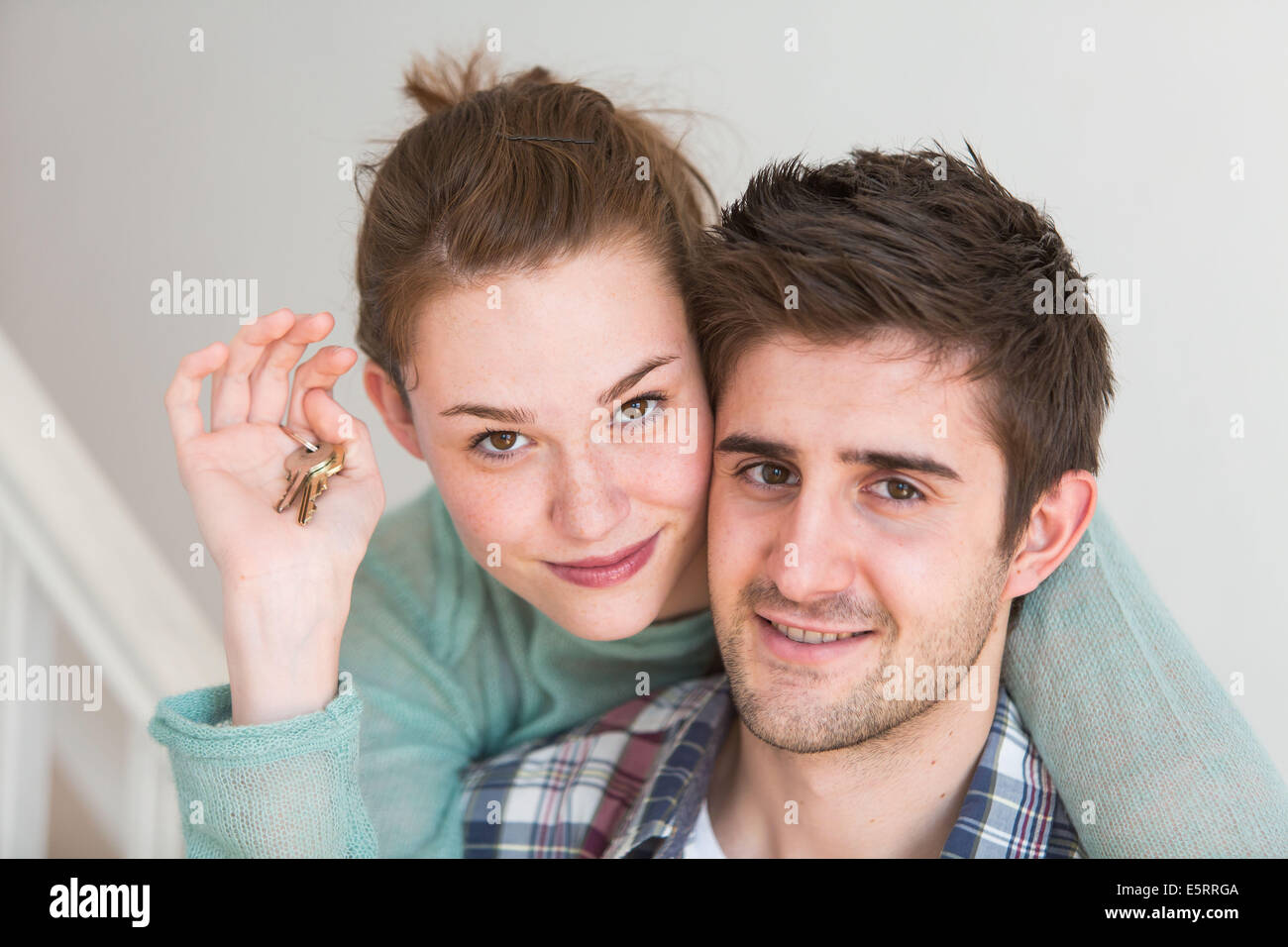 Young couple holding new house keys Stock Photo - Alamy