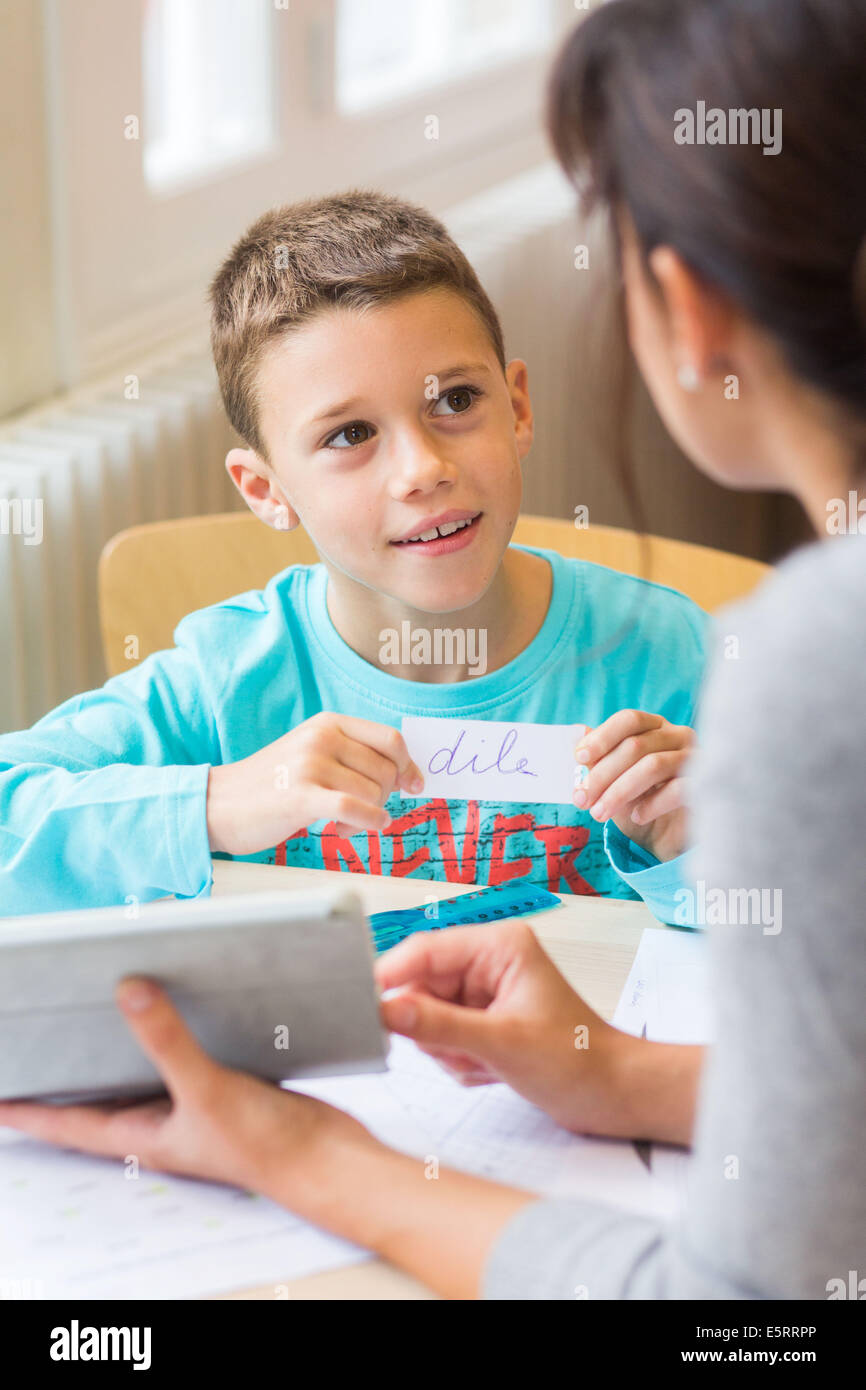 Teacher assisting a 7 year old boy. Stock Photo
