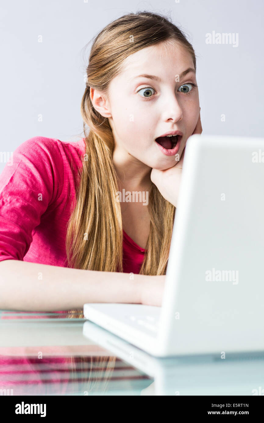 13-year-old teenage girl using laptop computer. Stock Photo