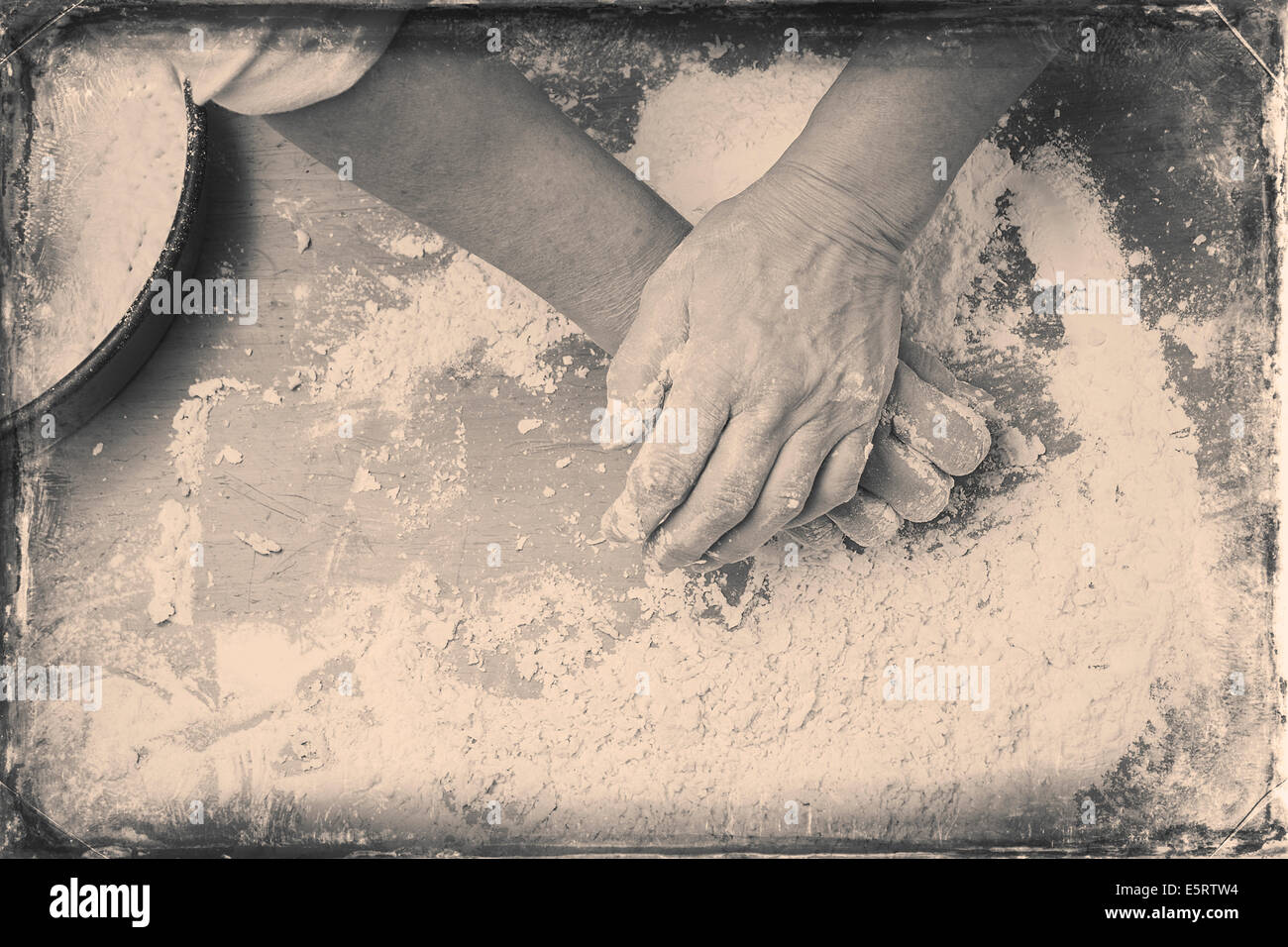 Closeup photo of baker making dough for bread. Retro styled black and