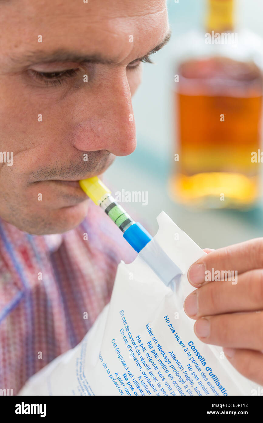 Woman using a breathalizer. Stock Photo
