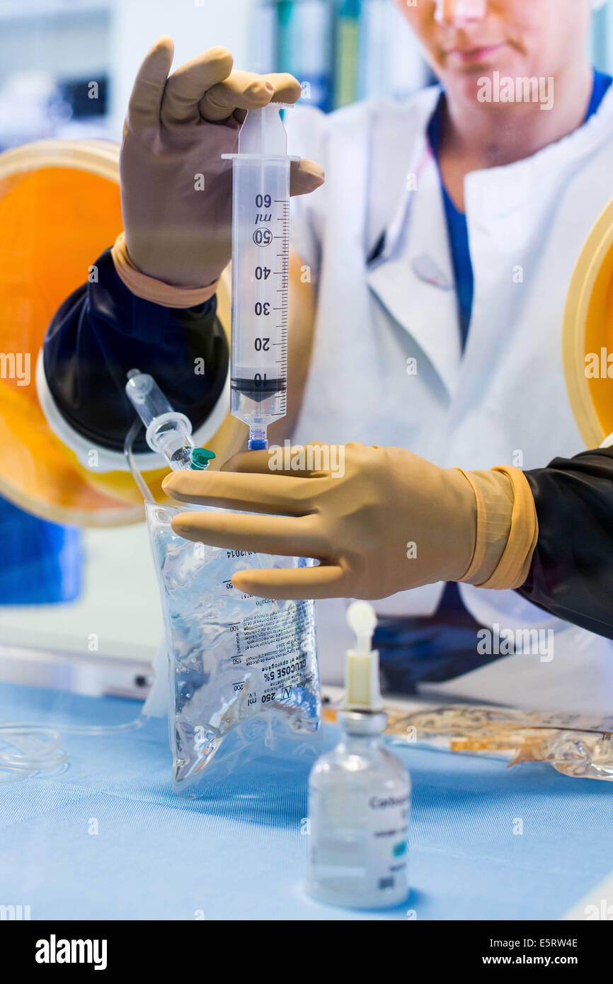 A compounder is preparing chemotherapy treatments under glove box