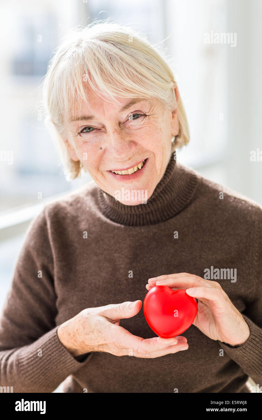 Woman holding heart Stock Photo Alamy