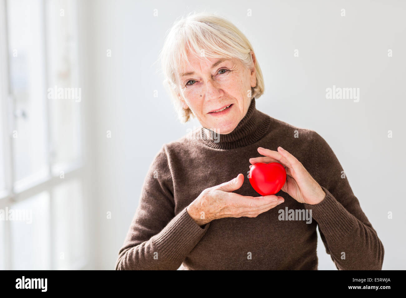 Woman holding heart Stock Photo Alamy