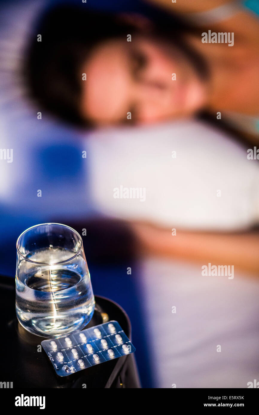 Woman taking medication in bed Stock Photo Alamy