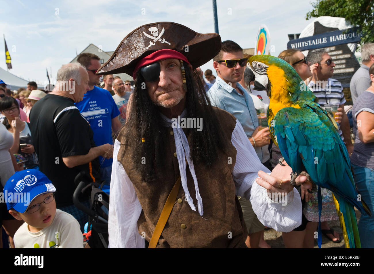 Pirate with parrot in carnival parade at Whitstable Oyster Festival Kent England UK Stock Photo
