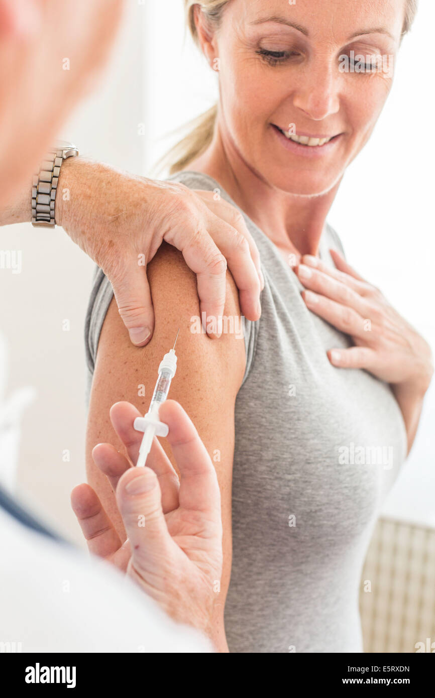 Woman receiving vaccination. Stock Photo