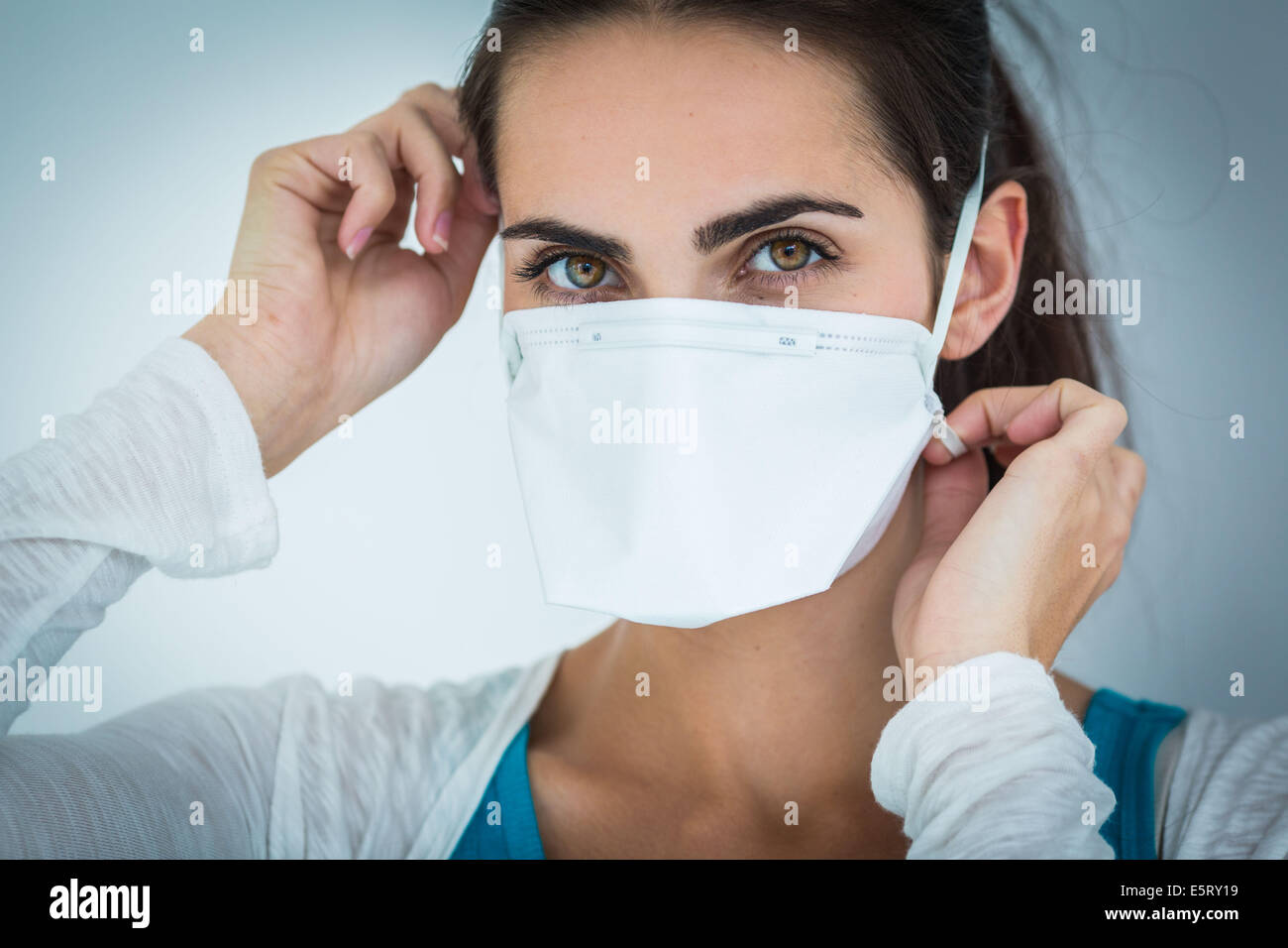 Woman wearing a face mask to protect herself from MERS-CoV. Stock Photo