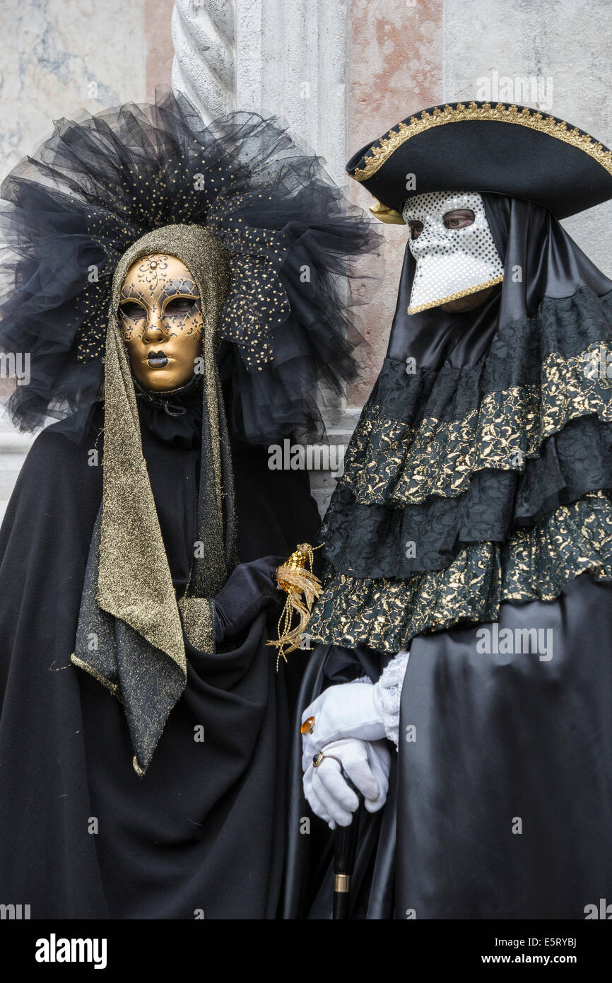 Couple in black with gold stylized eighteenth century costumes during ...