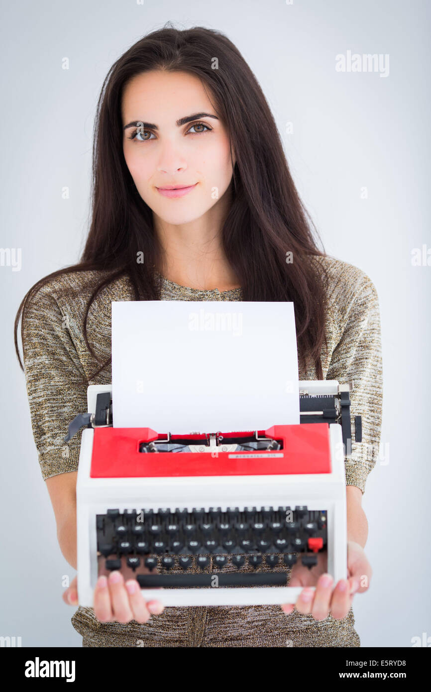 Woman holding a typewriter. Stock Photo