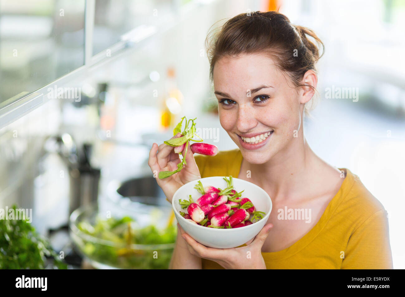 Woman eating radishes Stock Photo Alamy