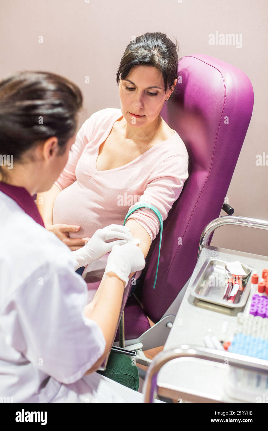 nurse-taking-a-blood-sample-from-a-pregnant-woman-in-a-medical