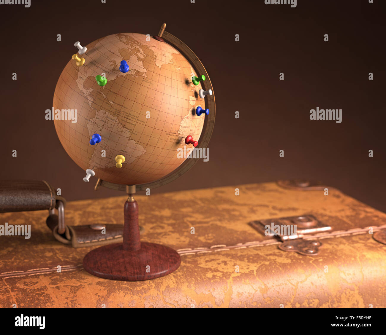 Old globe with pins marking the route of the trip on top a vintage suitcase. Stock Photo