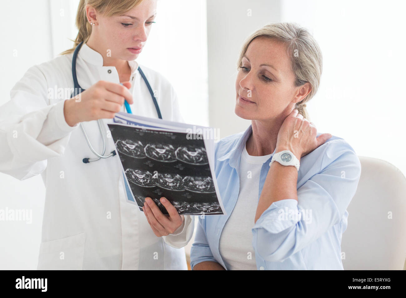 Doctor looking at a of the cervical spine CT-scan of her patient. Stock Photo