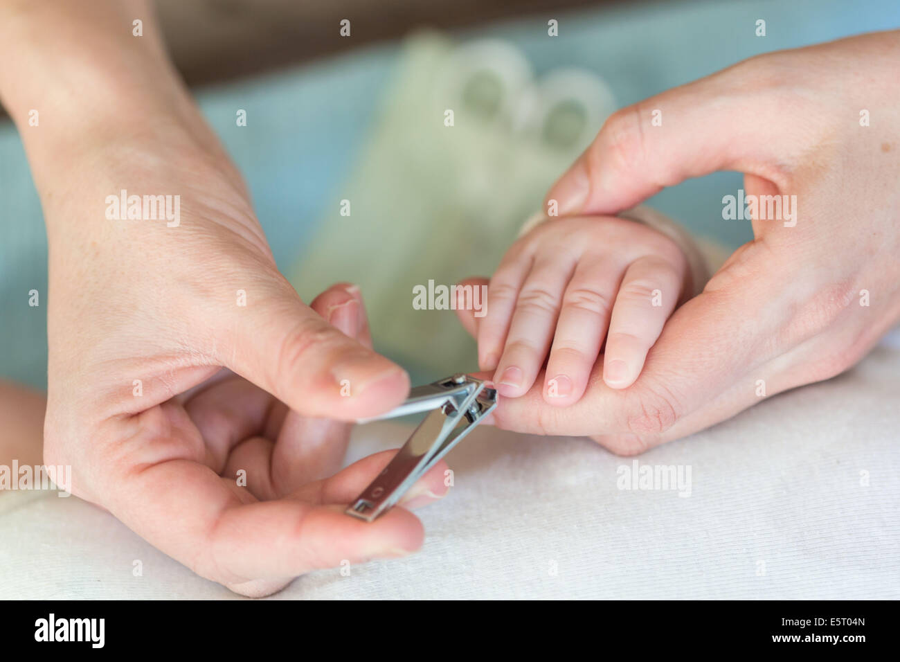 4 month old baby boy having fingernails cut Stock Photo Alamy