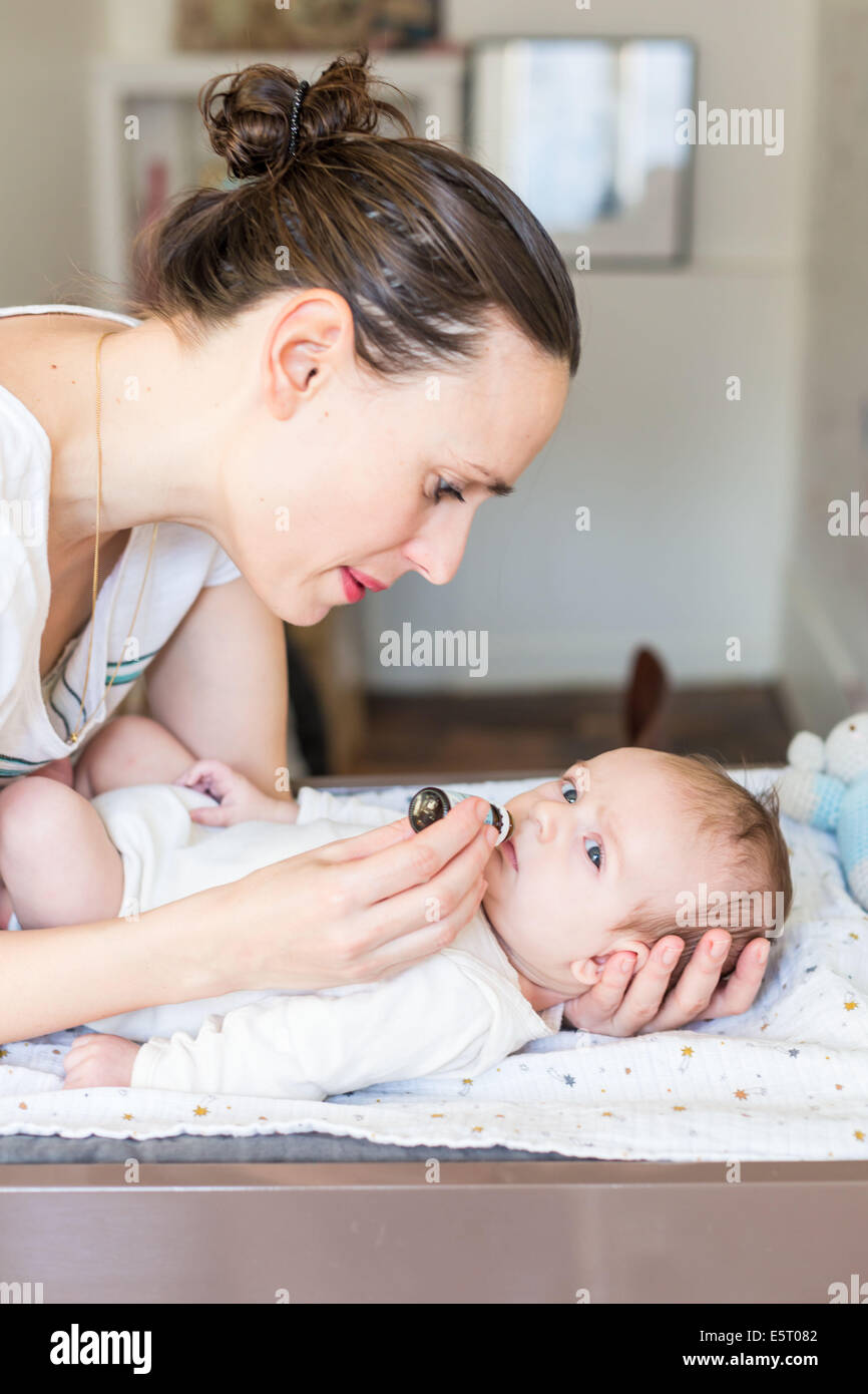 Mother giving drops of vitamin D to a 3 month old baby boy Stock Photo