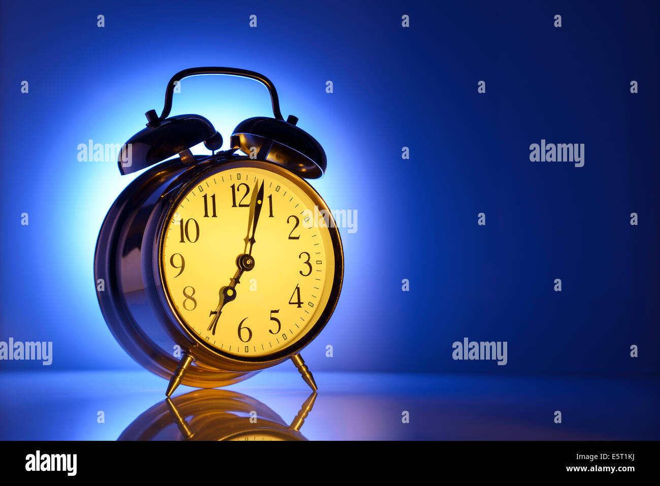 A classic alarm clock set for 7am Stock Photo