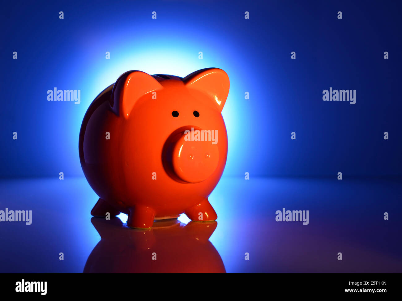 Spotlight on a red piggy bank Stock Photo