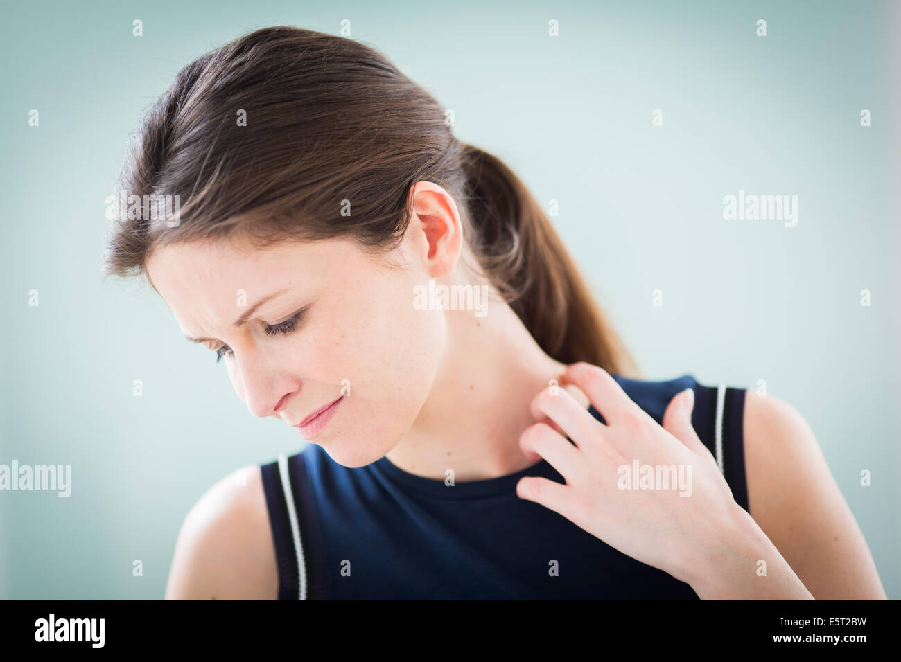 Woman itching her neck Stock Photo Alamy