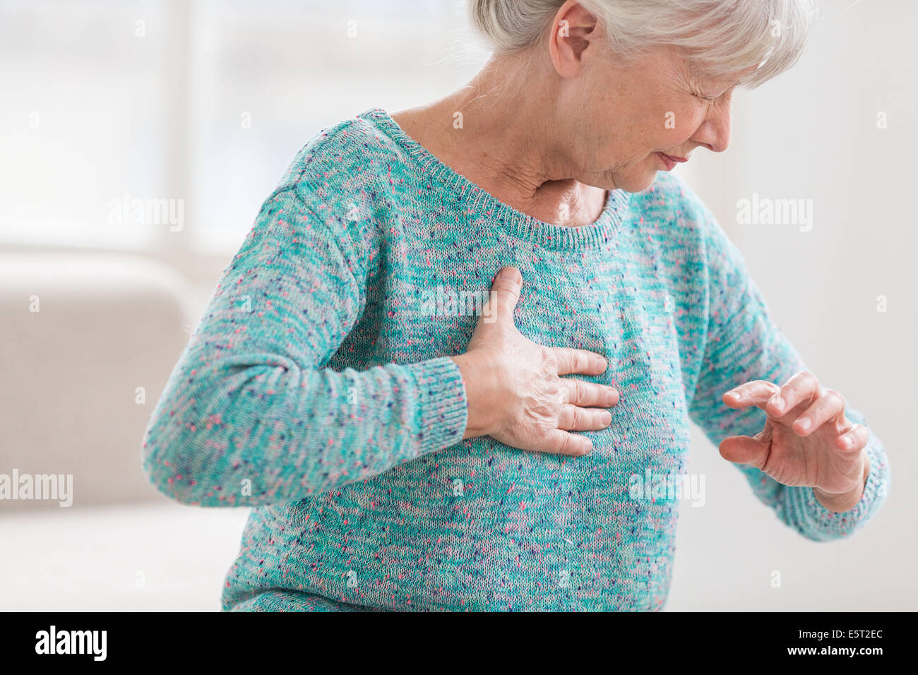 Woman suffering from a mild heart attack. Stock Photo
