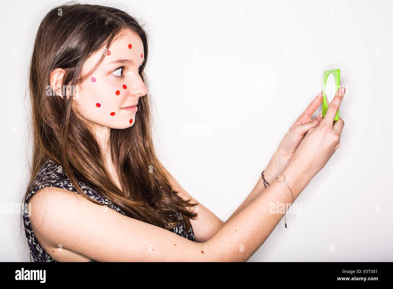 Humorous image of a teenage girl with pimples on the face. Stock Photo