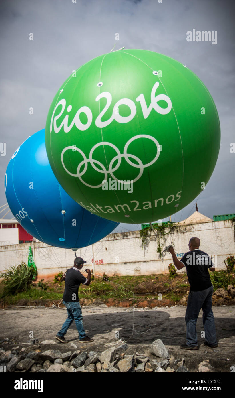 Worker carry huge balloons next to the Olympic Park in Barra two years  prior to the Rio2016 Olympic Games, 05. August 2014, in Rio de Janeiro in  Brazil. The balloons mark the