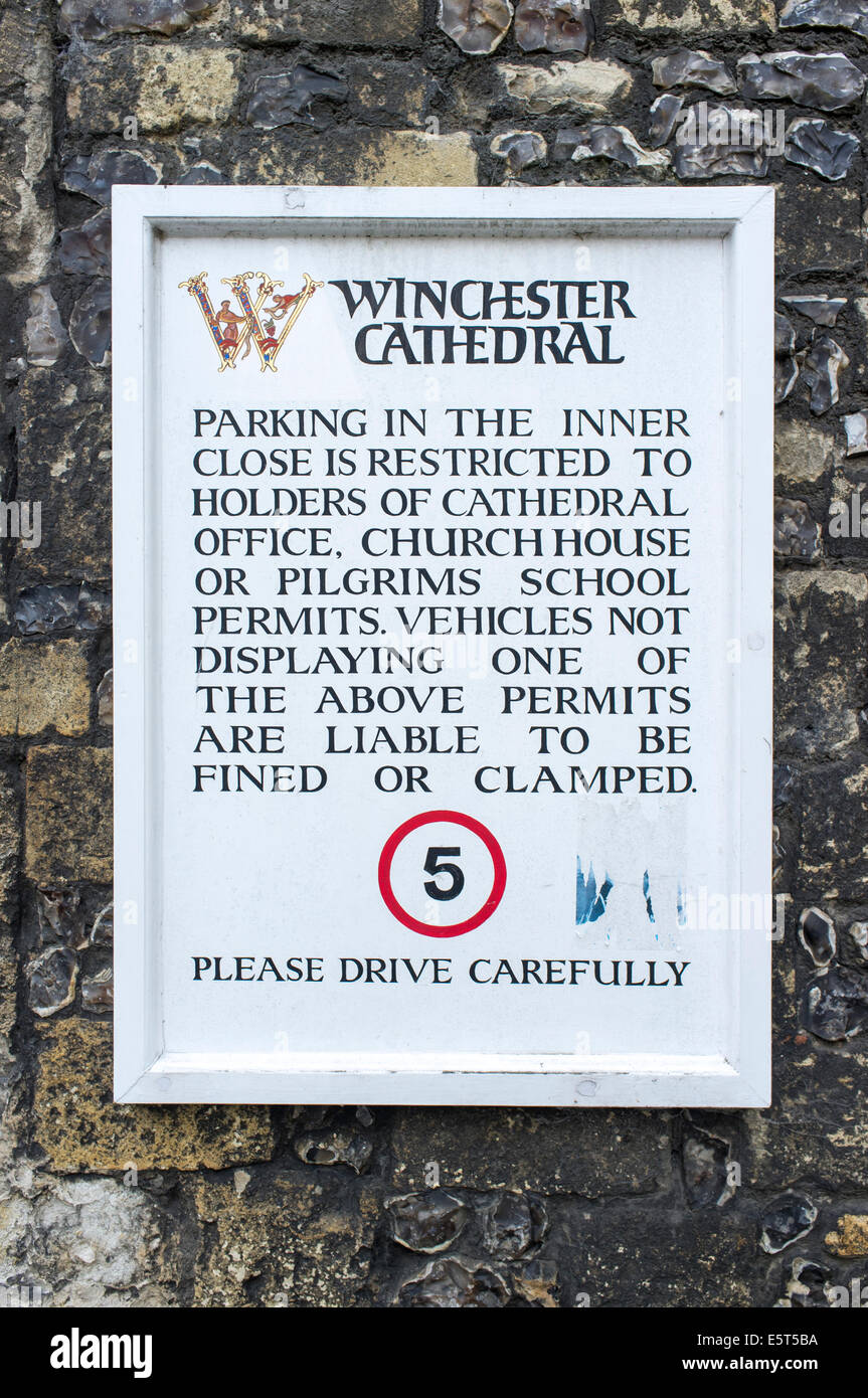 Parking restriction notice and speed limit sign at Priory Gate entrance to Winchester Cathedral UK Stock Photo