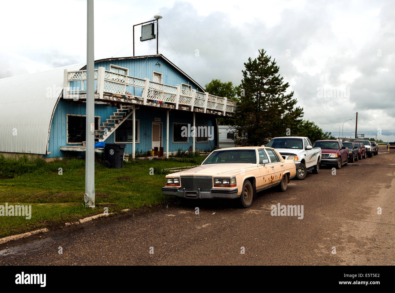 Rusty Cadillac on run down street in rural Alberta,Canada Stock Photo