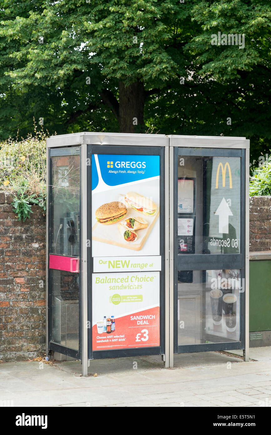 Food advertising on UK public telephone kiosks Stock Photo