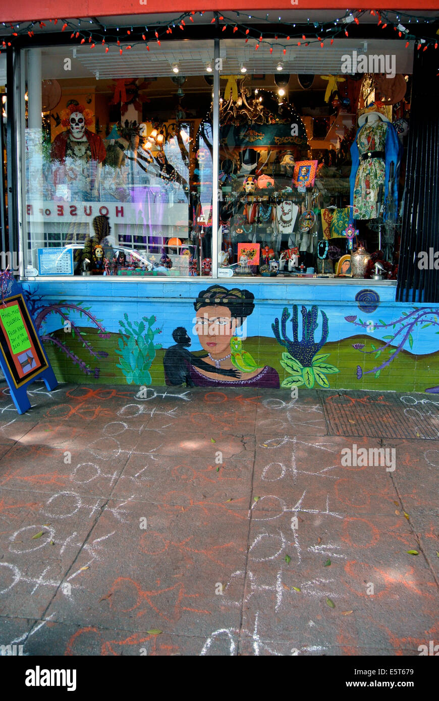 Political graffiti on sidewalk in front of shop in Mission District San Francisco Stock Photo