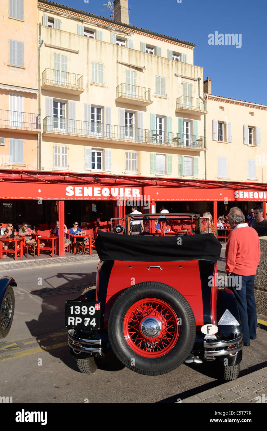 Tourists Admire a Vintage Peugeot 601 Car 1934-35 in front of the Senequier Pavement Café on Quai Jean Jaurès Saint Tropez Var Proence France Stock Photo