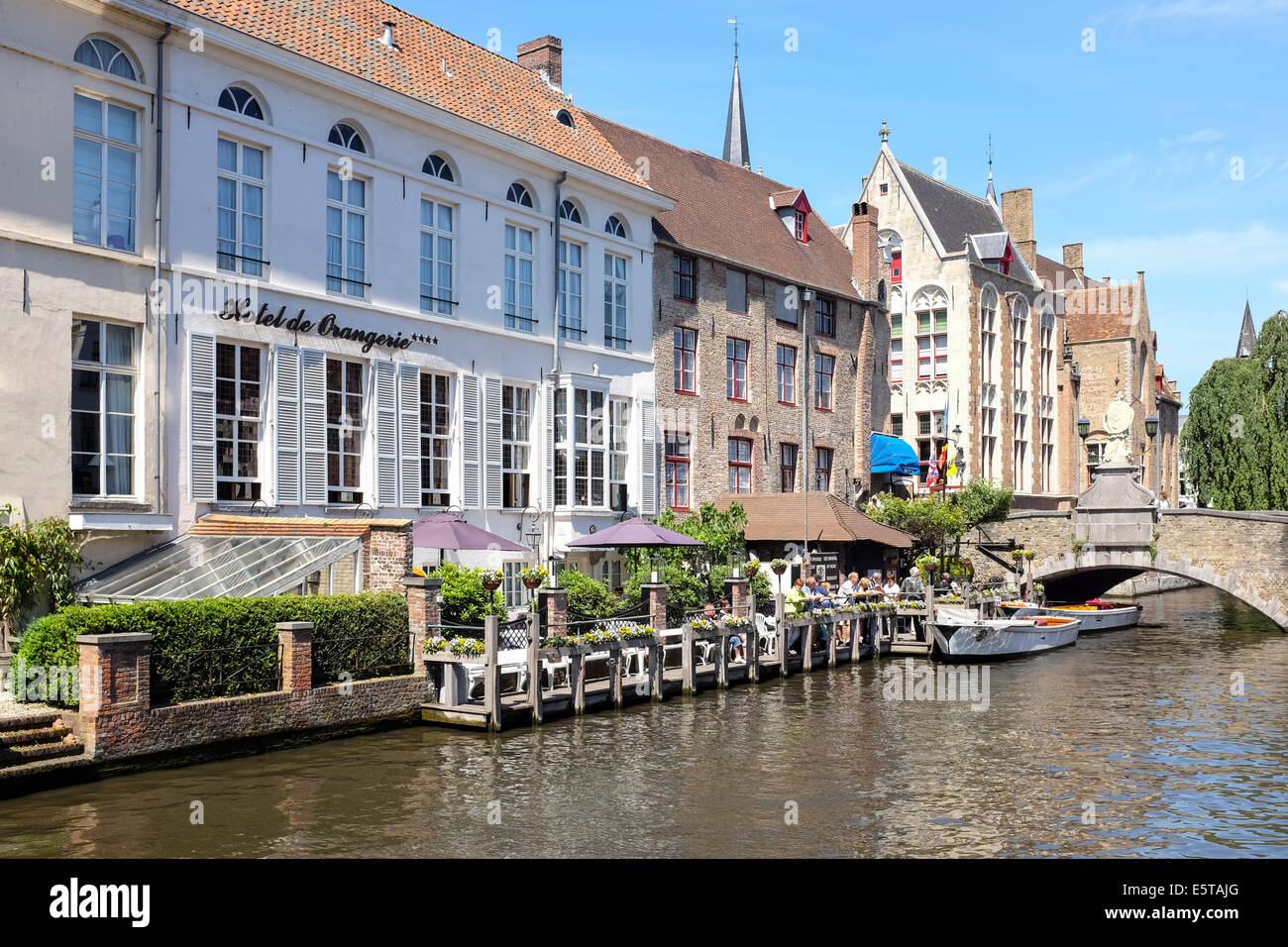 Tourist waiting to take a boat trip at Bruges canal, Belgium Stock Photo