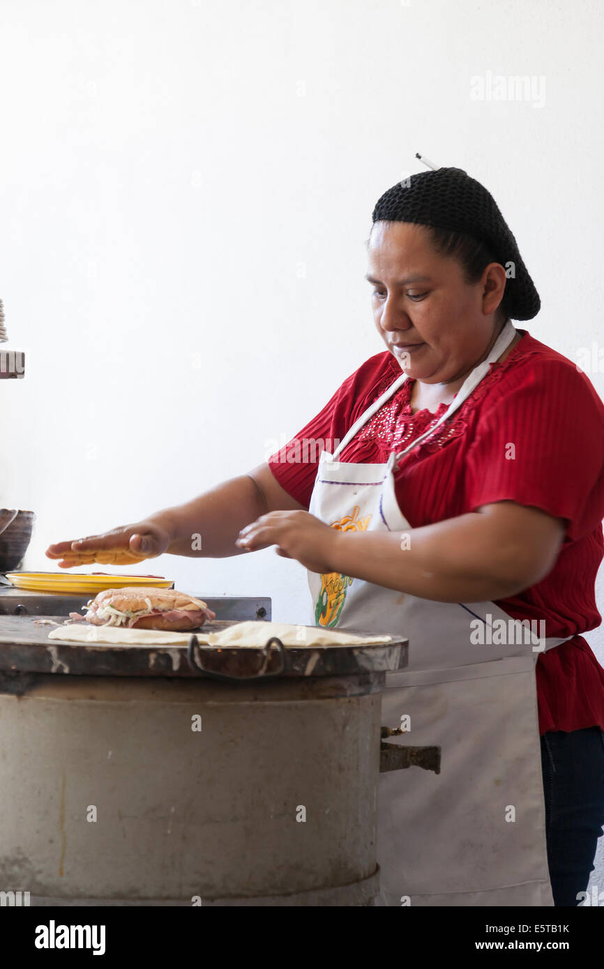 Woman making a torta on a comal at Mi Taquito taquería in the Centro  Historico Stock Photo - Alamy