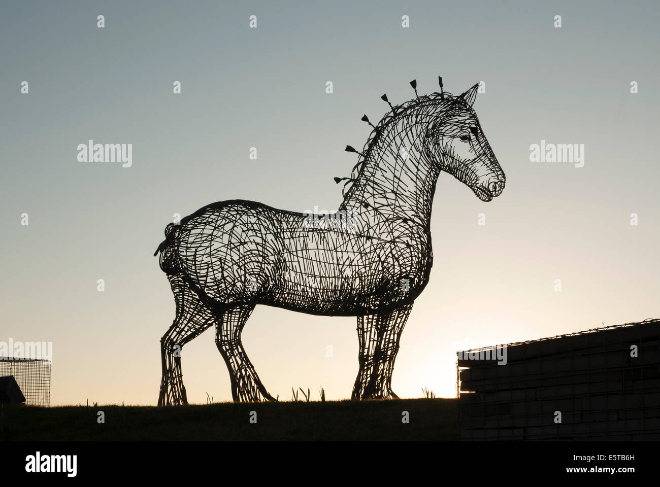 Andy Scott's Heavy Horse Sculpture overlooking  the M8 Motorway at dusk. Stock Photo