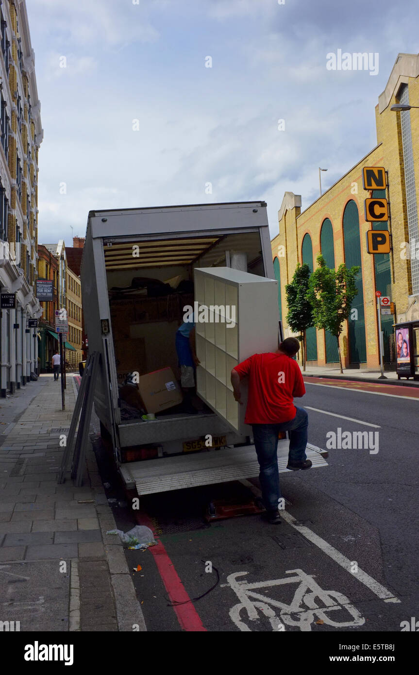 removal men loading furniture into truck Stock Photo Alamy
