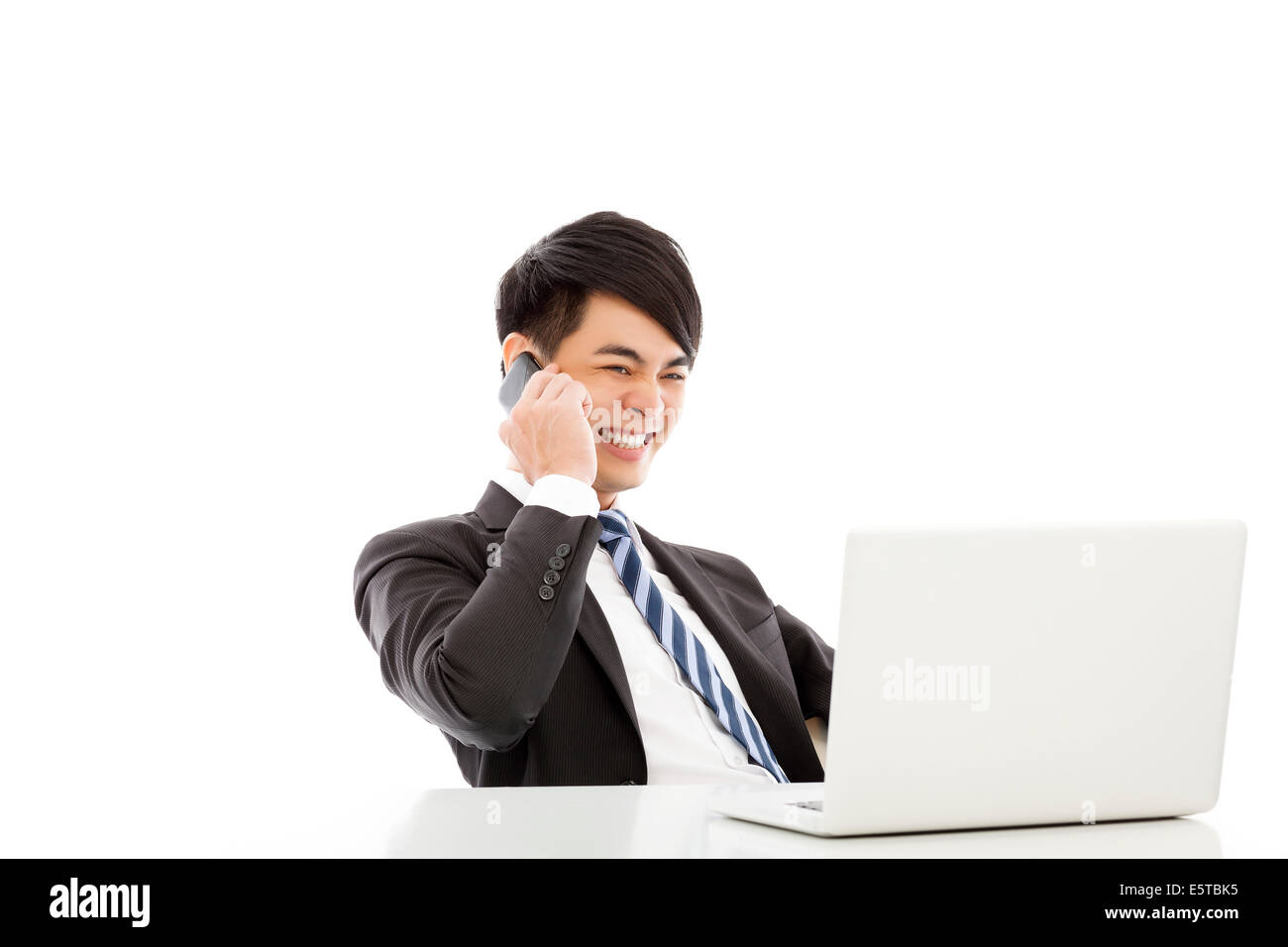 smiling business man talking happily by smart phone Stock Photo