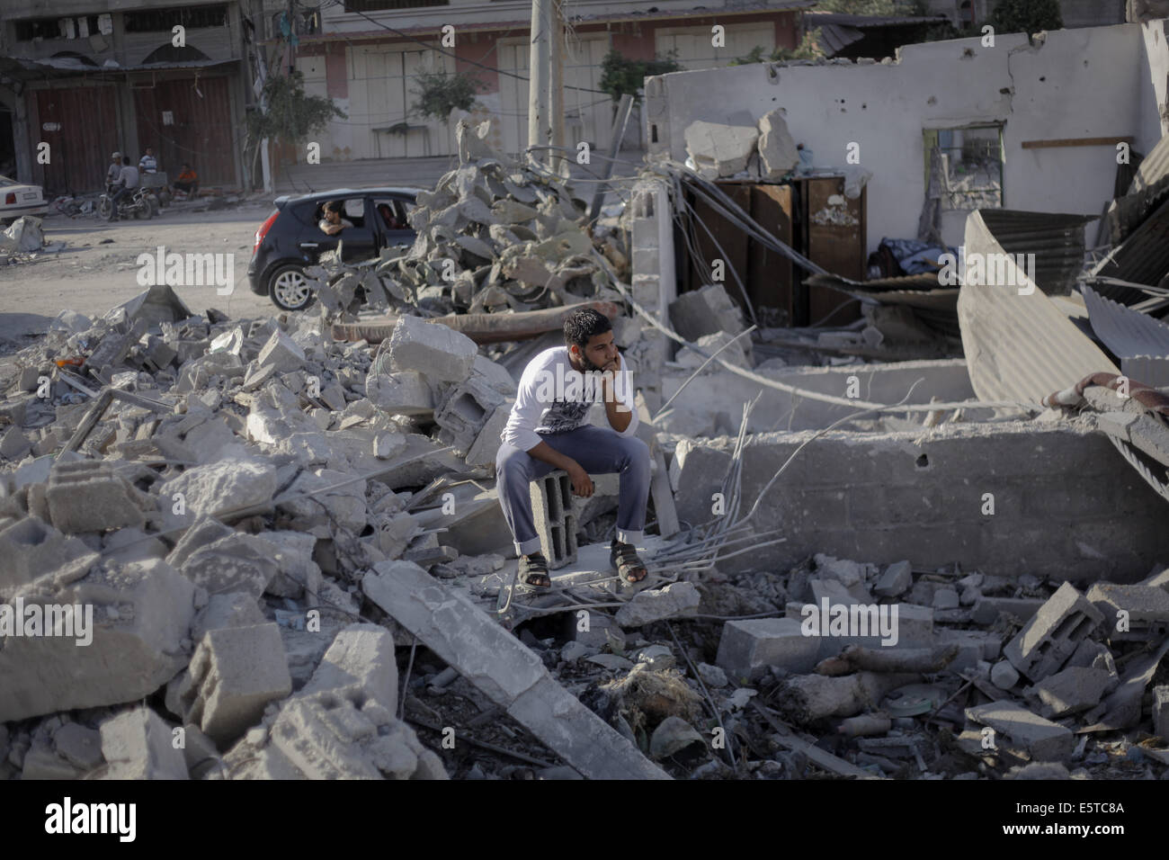 Gaza. 5th Aug, 2014. A Palestinian man sadly sits on the rubble of his ...