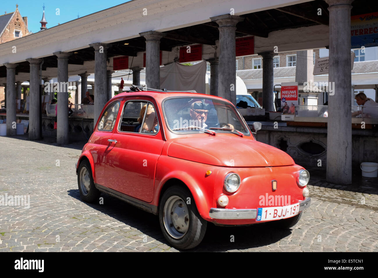 Red Vintage Fiat Cinquecento in the Vismarkt or Fish Market of Bruges old town, Belgium Stock Photo