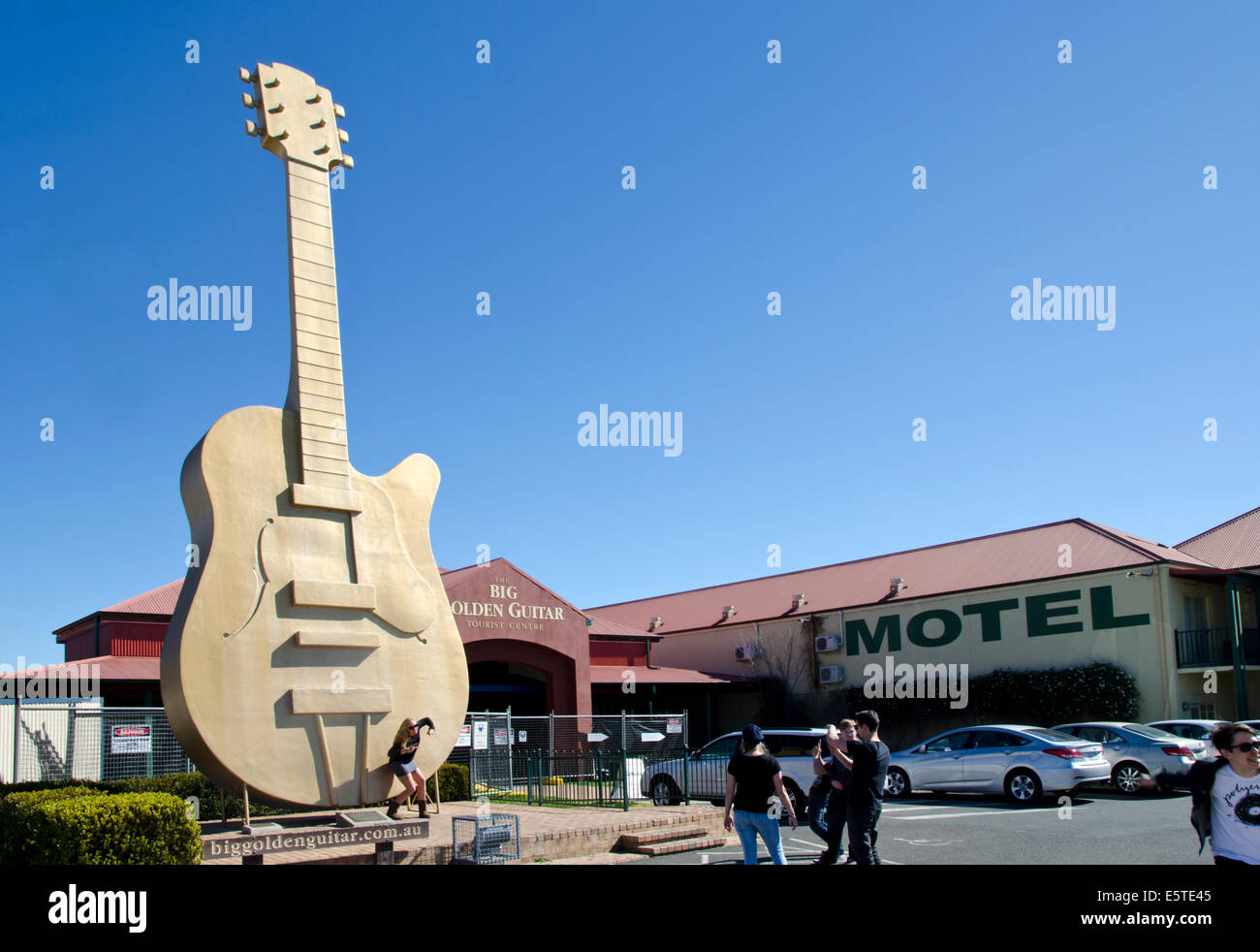 Tourists posing in front of the Big Golden Guitar, Tamworth Australia Stock Photo